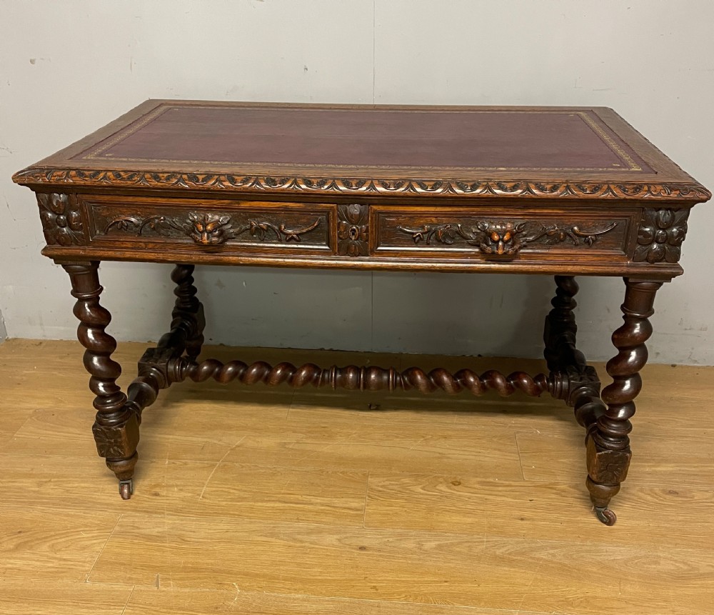C19th Carved Oak Jacobean style writing Table With tooled leather top 