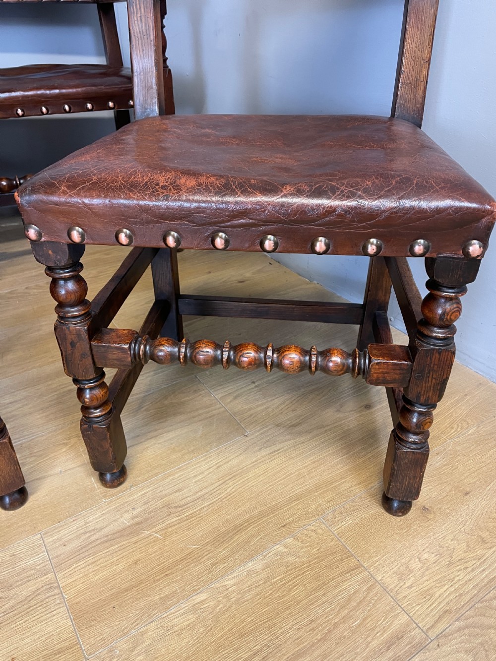 Eight Jacobean style leather and oak dining chairs circa 1890 View III