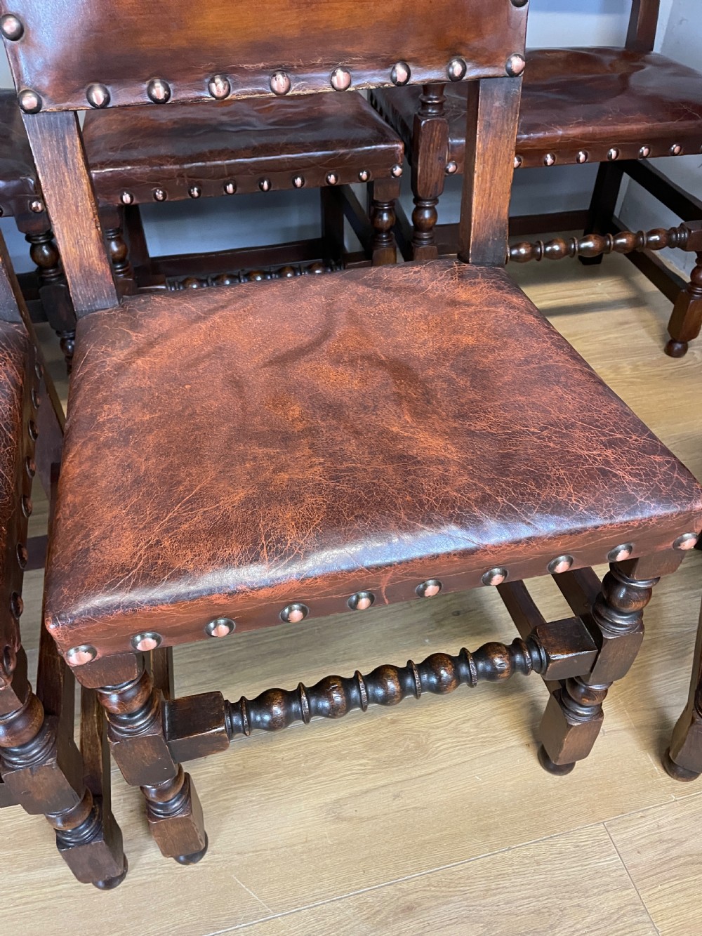 Eight Jacobean style leather and oak dining chairs circa 1890 View V