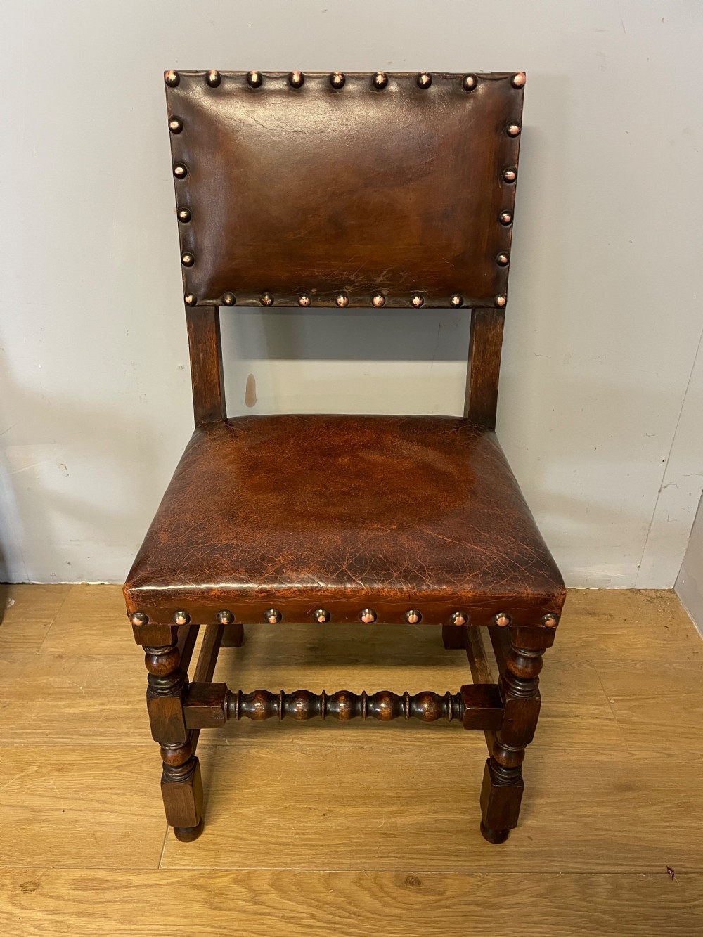 Eight Jacobean style leather and oak dining chairs circa 1890 View XI