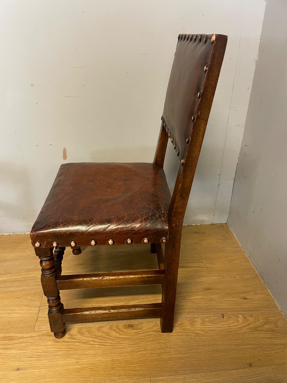 Eight Jacobean style leather and oak dining chairs circa 1890 View XII