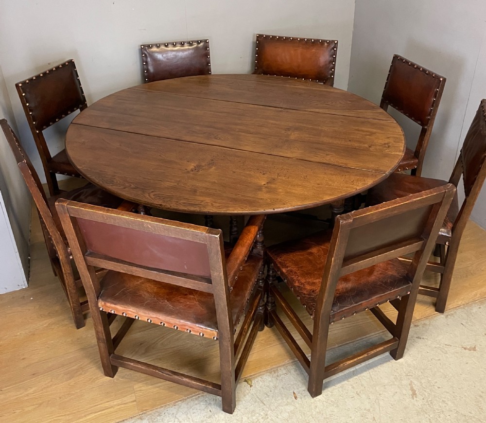 Eight Jacobean style leather and oak dining chairs circa 1890 View XVI