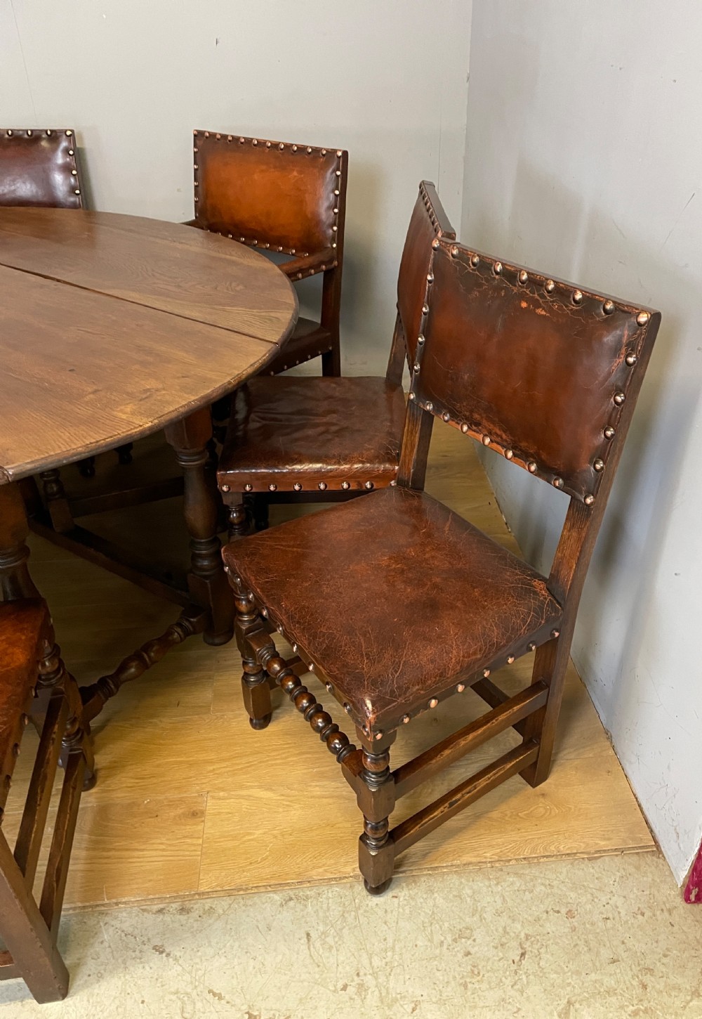 Eight Jacobean style leather and oak dining chairs circa 1890 View XVII