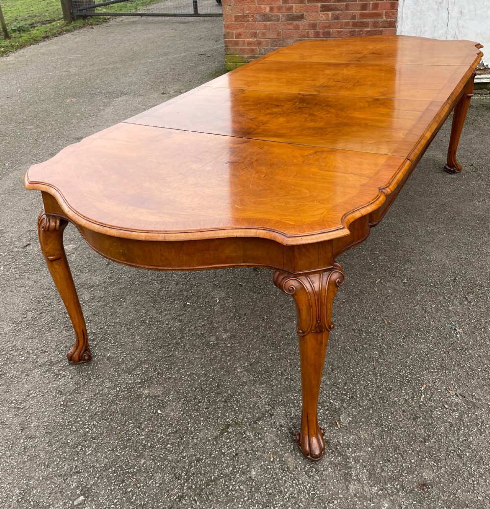 Burr walnut extending eight seater Queen Anne style dining table 
