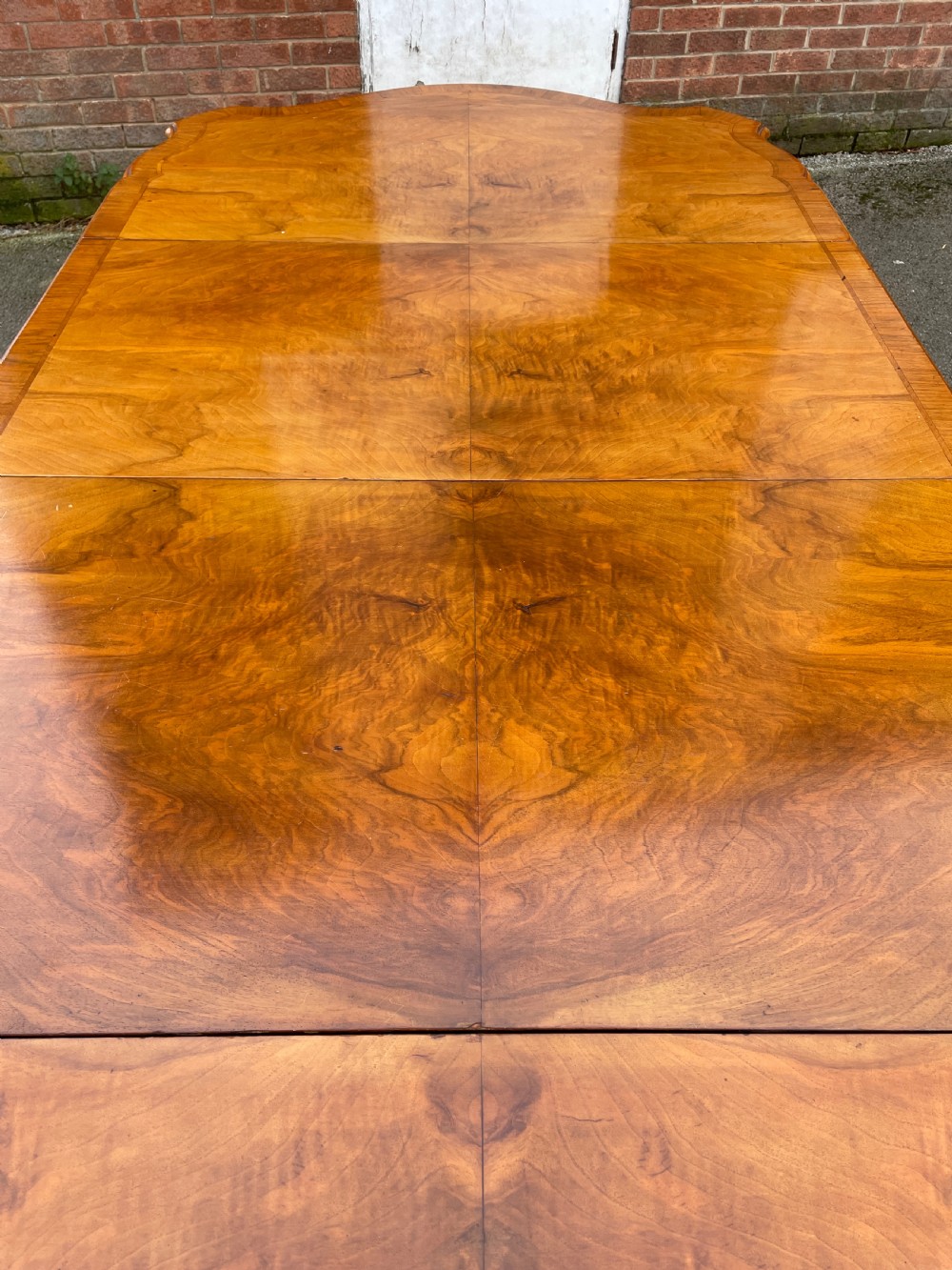 Burr walnut extending eight seater Queen Anne style dining table  View VI