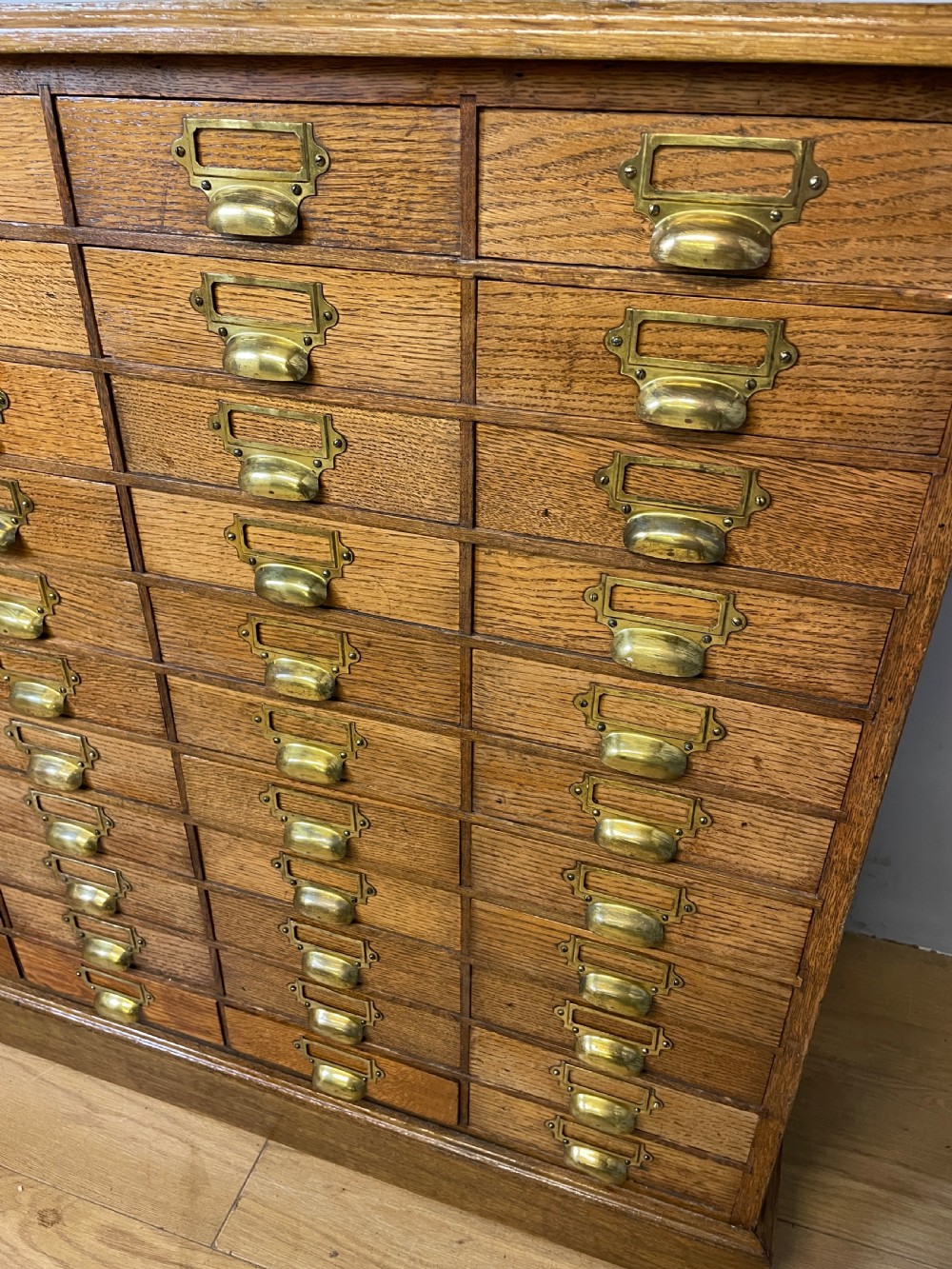 Edwardian set of 66 oak filing drawers with original brass fittings  View IV