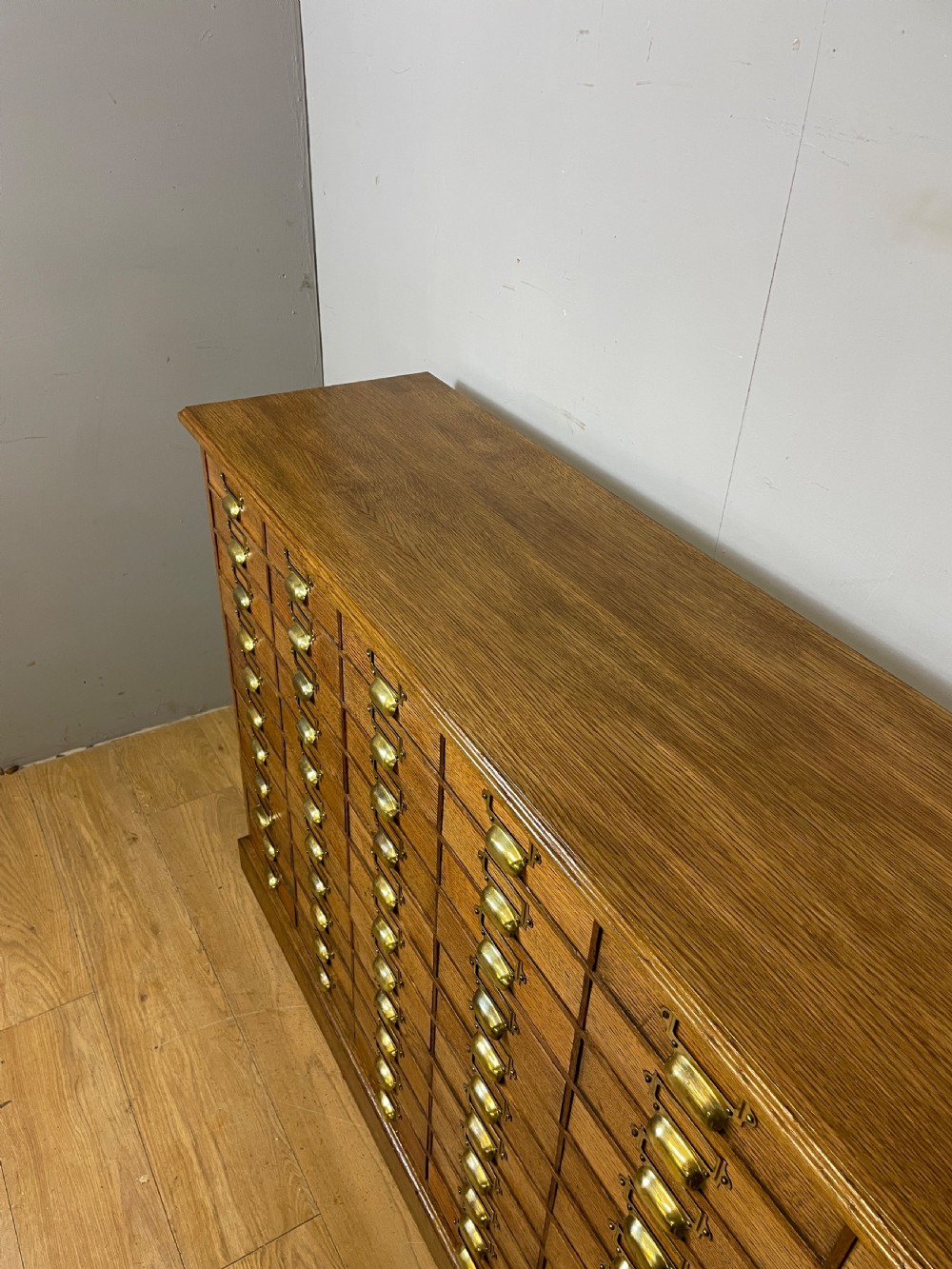 Edwardian set of 66 oak filing drawers with original brass fittings  View VI