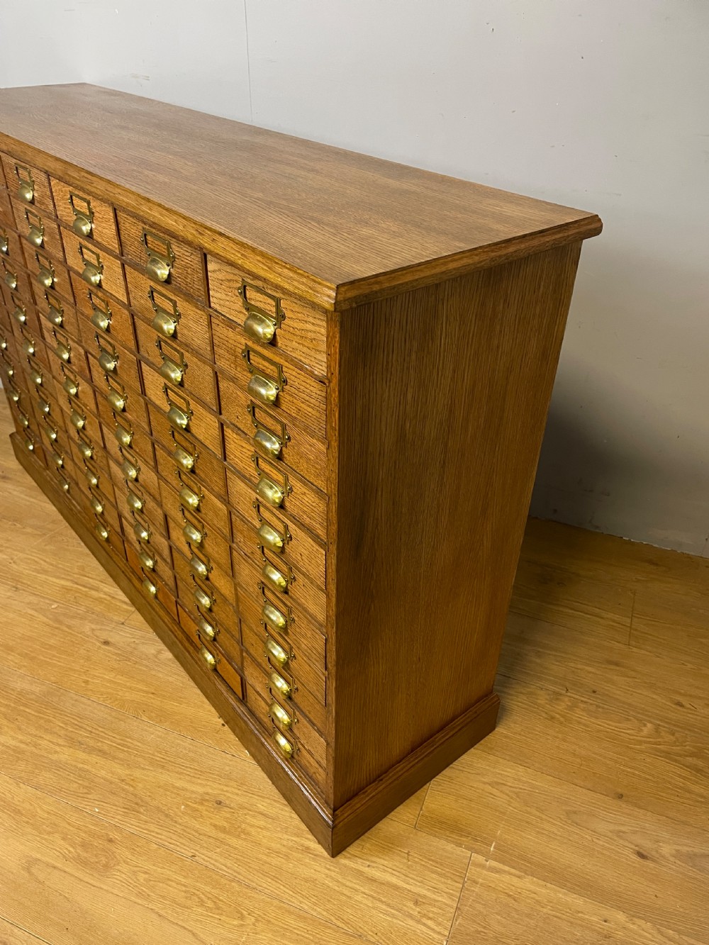 Edwardian set of 66 oak filing drawers with original brass fittings  View VII