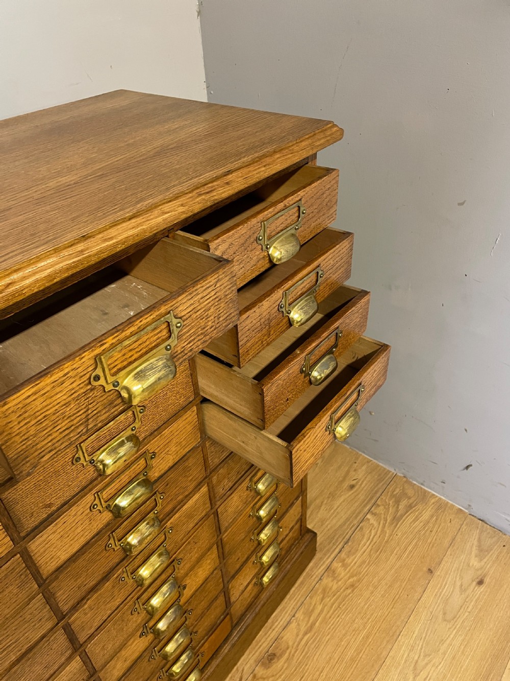 Edwardian set of 66 oak filing drawers with original brass fittings  View X