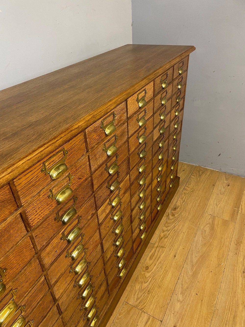 Edwardian set of 66 oak filing drawers with original brass fittings  View XI