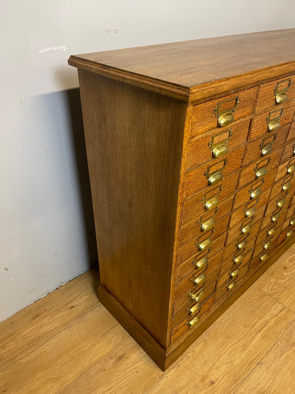 Edwardian set of 66 oak filing drawers with original brass fittings  View XV