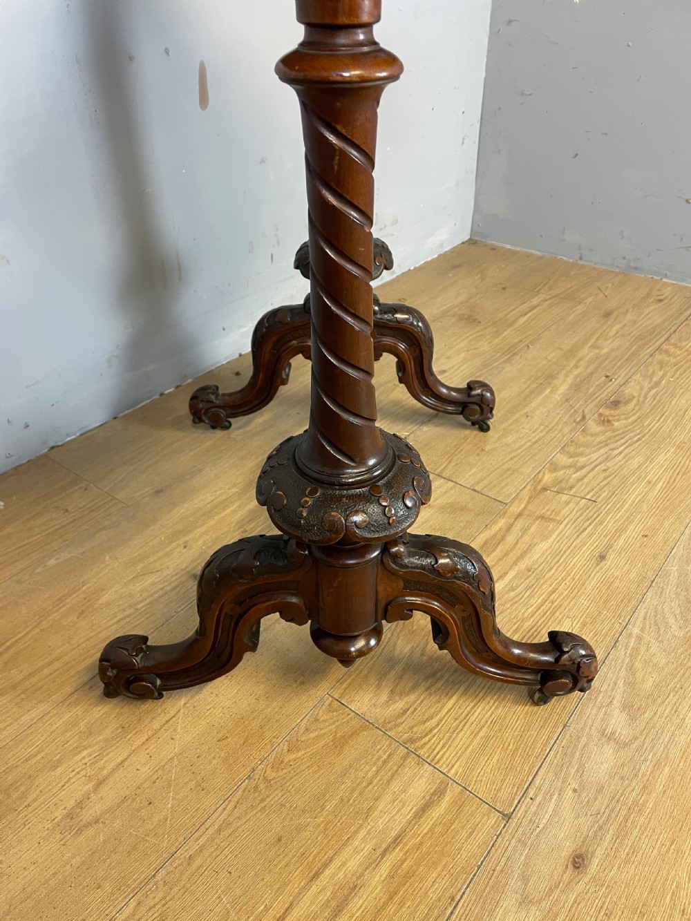 A Victorian burr walnut work table shown with its hinged lid open, revealing intricate fretwork covers, internal compartments, and carved turned legs. View VIII