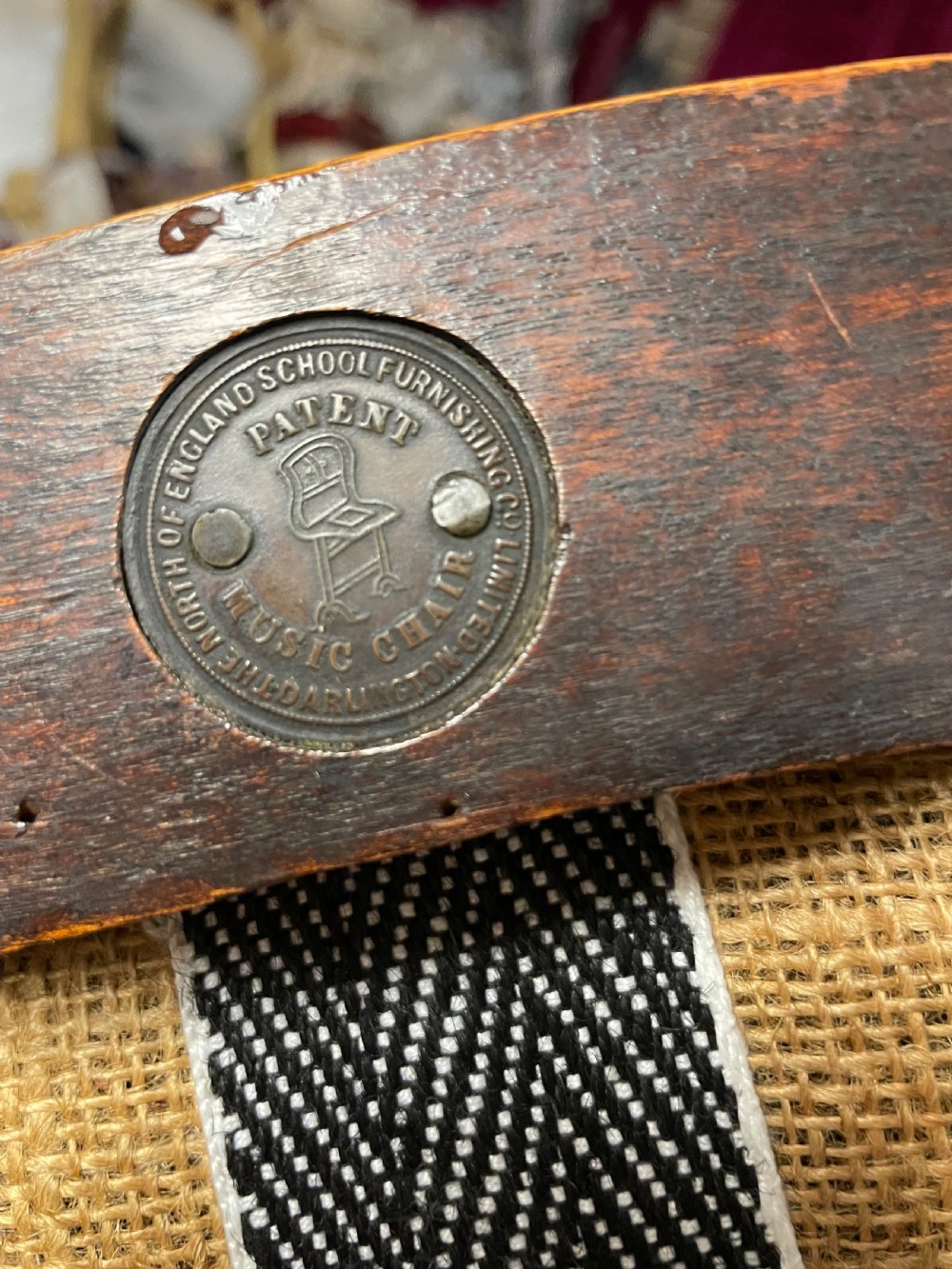A late nineteenth-century Victorian patent music chair in polished oak featuring a green leather seat and lumbar pad trimmed with brass studs. View IV