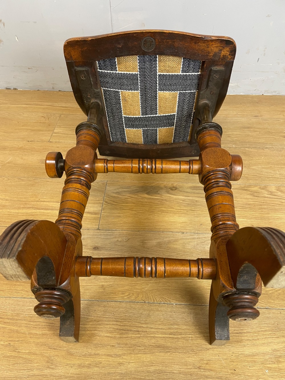 A late nineteenth-century Victorian patent music chair in polished oak featuring a green leather seat and lumbar pad trimmed with brass studs. View XIII