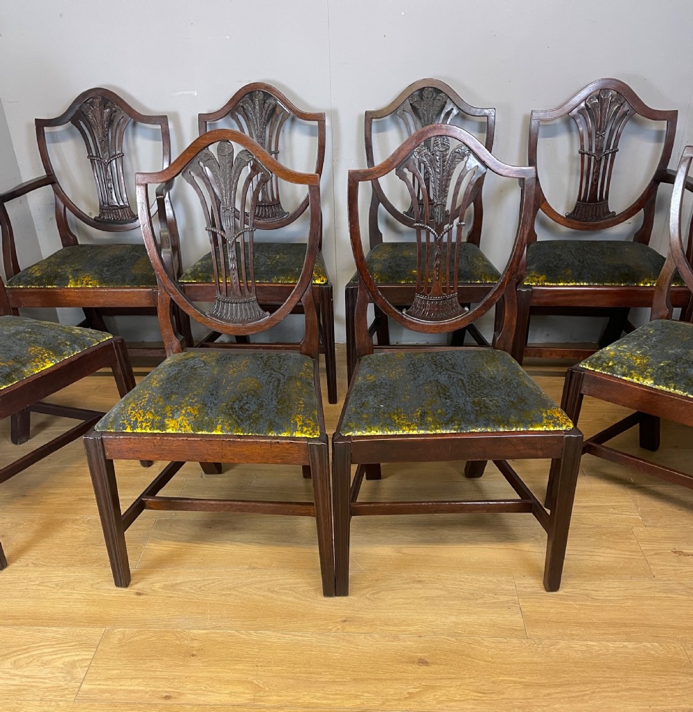 Set of eight Georgian mahogany shield back dining chairs including two armchairs with carved splats and patterned upholstered seats. View II