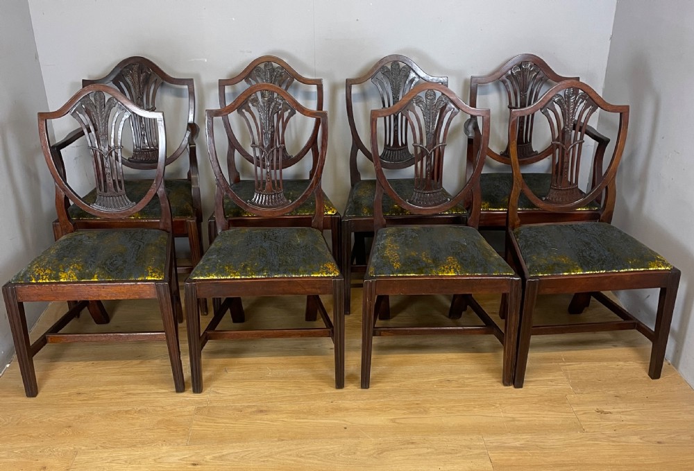 Set of eight Georgian mahogany shield back dining chairs including two armchairs with carved splats and patterned upholstered seats. View V