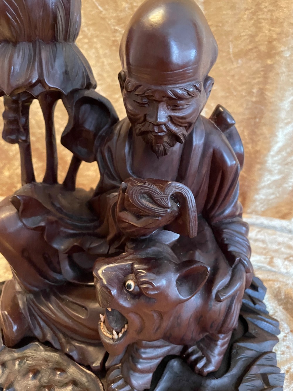 Late nineteenth-century Chinese carved dark wood table lamp depicting a seated scholar figure reading beside a tiger on a carved base with brass bulb holder. View III