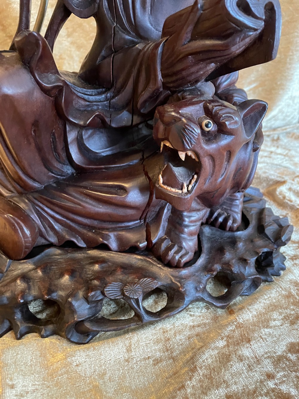 Late nineteenth-century Chinese carved dark wood table lamp depicting a seated scholar figure reading beside a tiger on a carved base with brass bulb holder. View IV