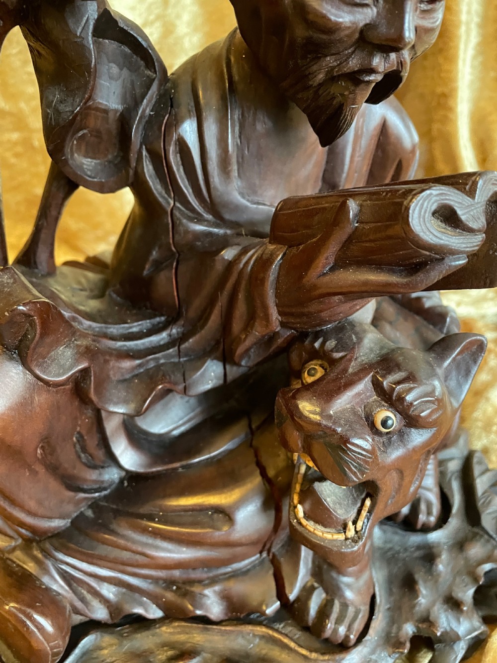 Late nineteenth-century Chinese carved dark wood table lamp depicting a seated scholar figure reading beside a tiger on a carved base with brass bulb holder. View IX