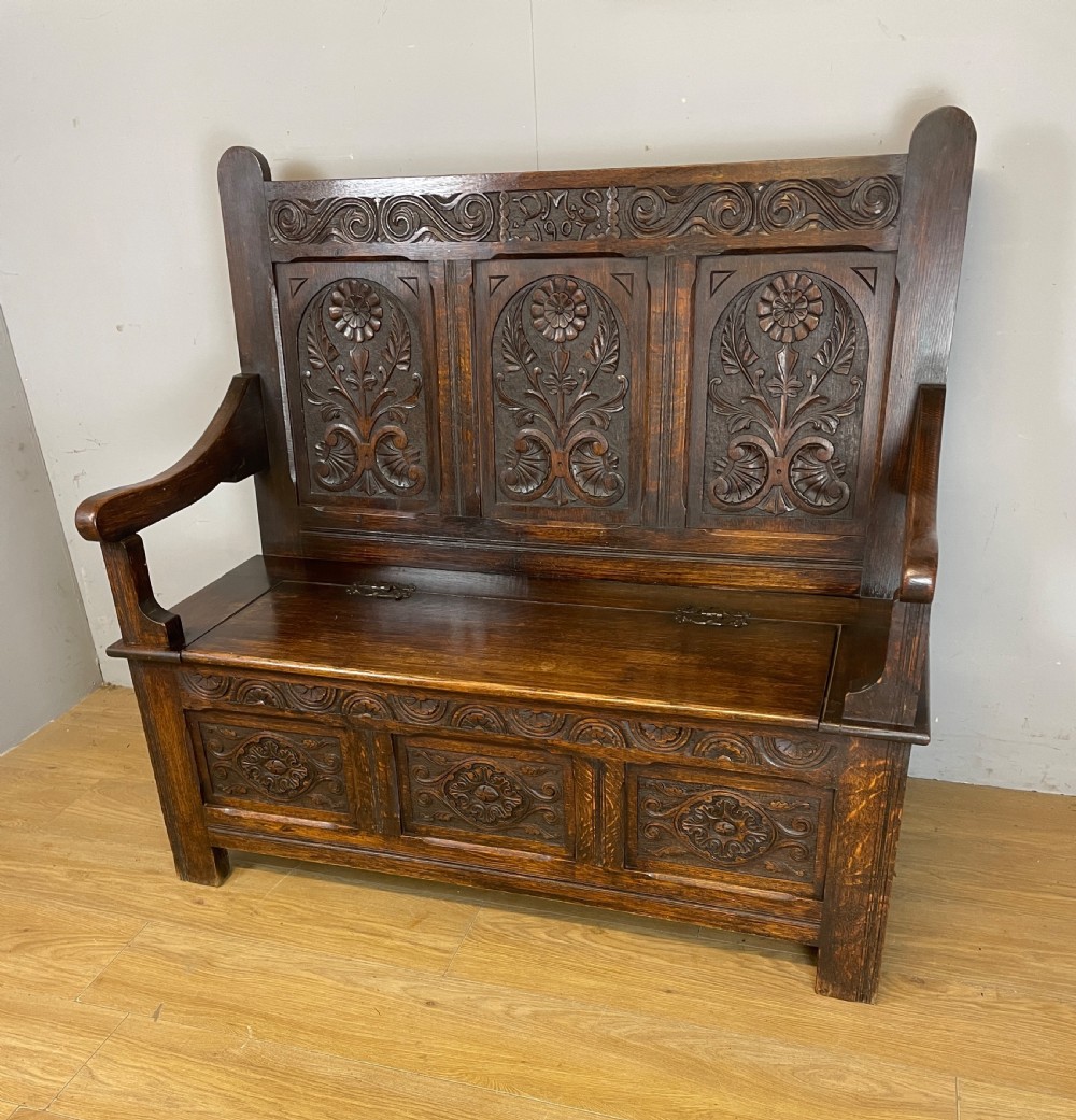 Arts and crafts solid oak carved box settle dated 1907 View II