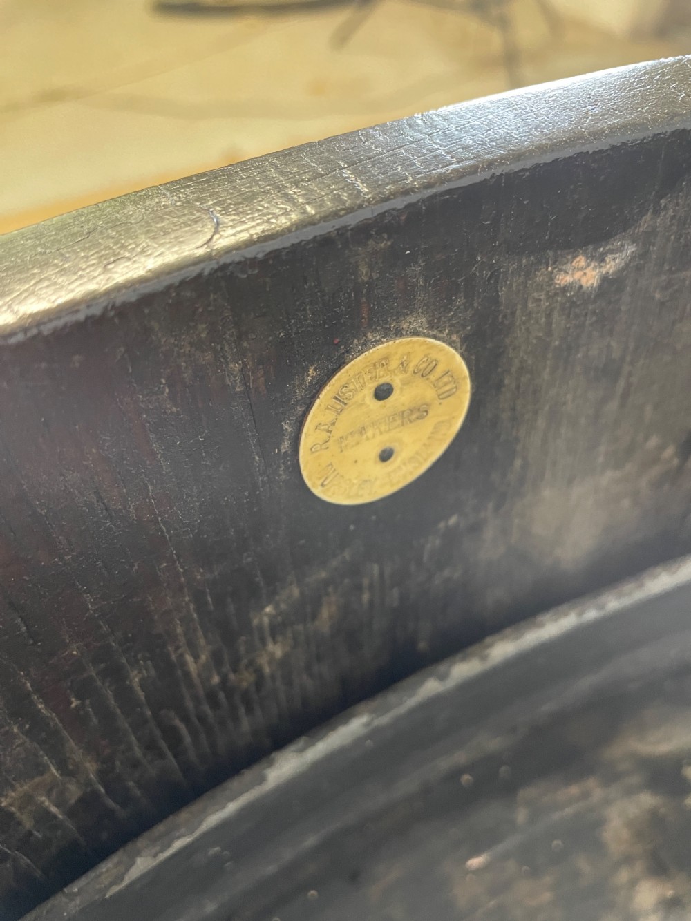 An Edwardian dark oak coopered circular planter with polished brass binding bands, raised on a three-legged wooden stand. View V