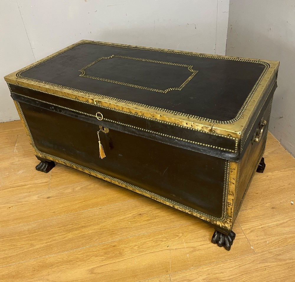 Regency brass studded leather camphor wood lined trunk on hairy paw feet 