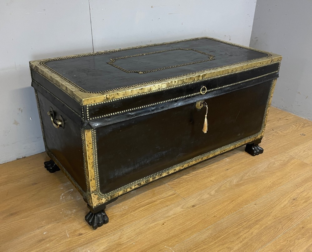 Regency brass studded leather camphor wood lined trunk on hairy paw feet  View II