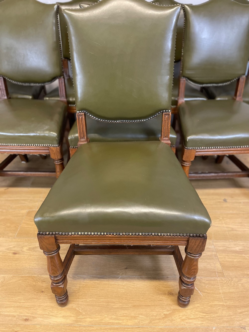 Arts and crafts golden oak set of eight dining chairs in green leather  View III