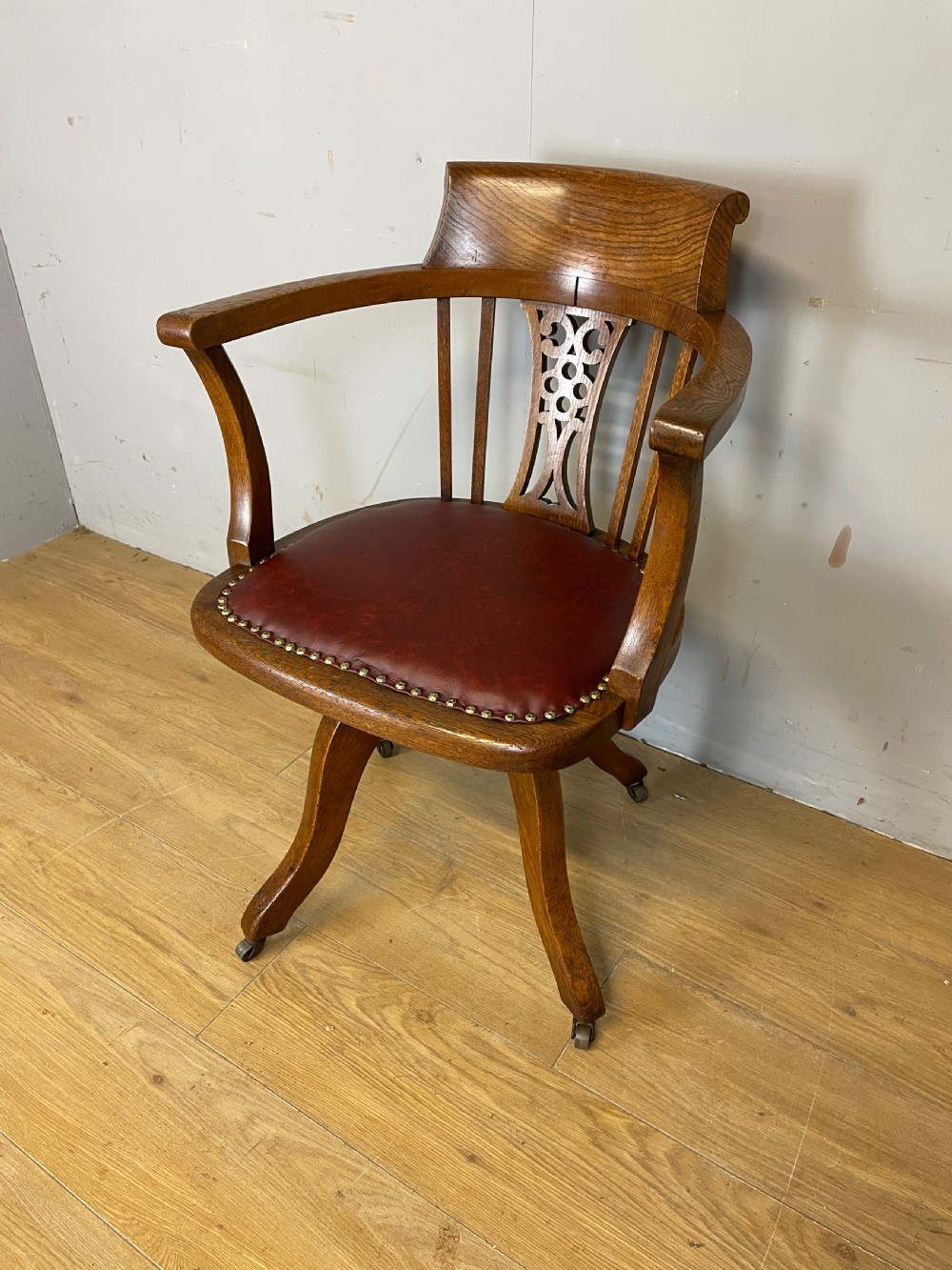 Edwardian oak revolving desk chair with red leather seat circa 1910 View II