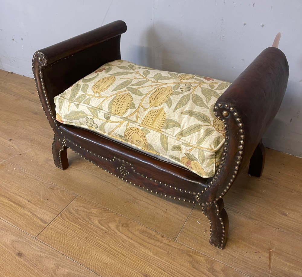 Arts and crafts leather footstool with decorative brass studs  View IX