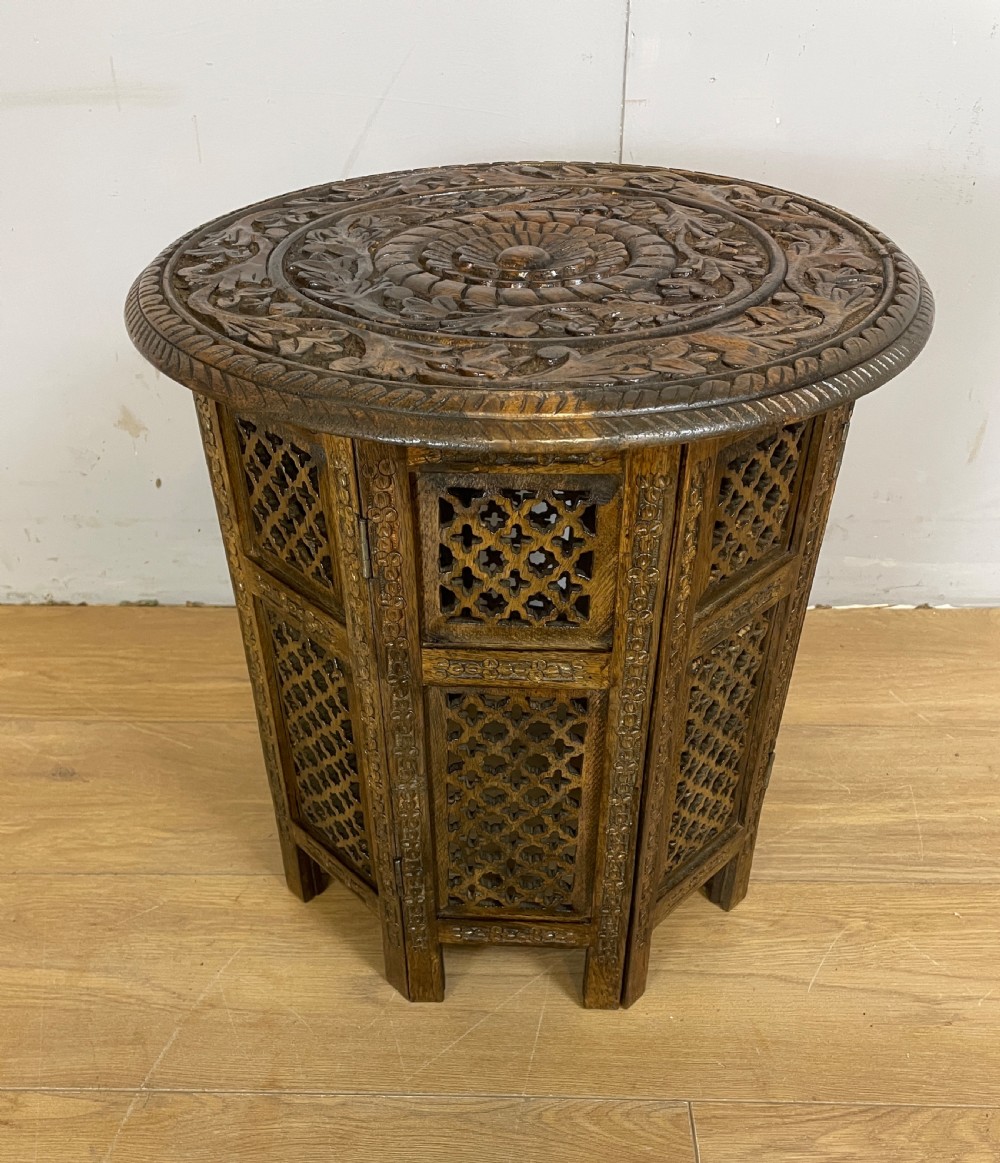 Carved circular oriental table on an octagonal base  View VI