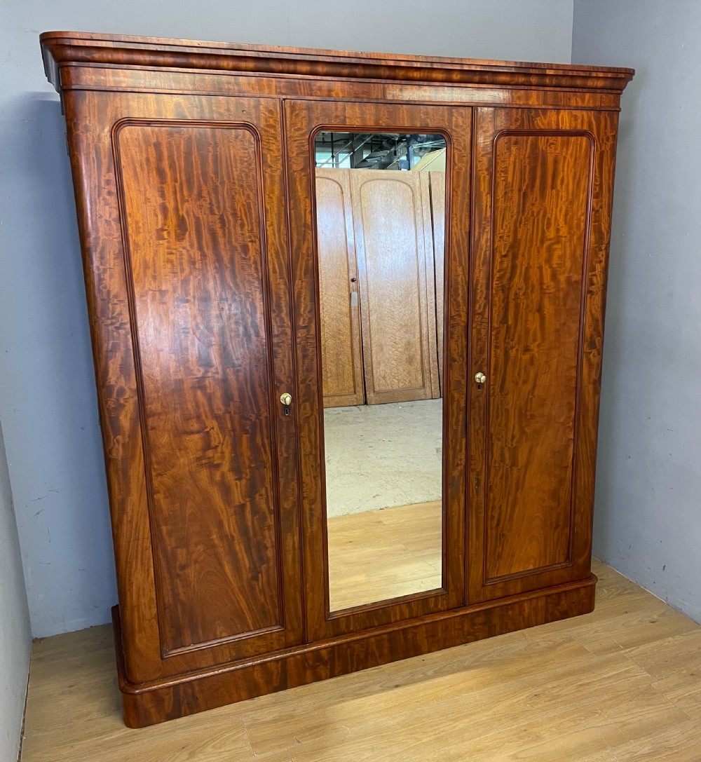 C19TH country house flame mahogany triple wardrobe 