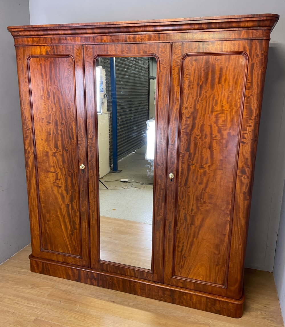 C19TH country house flame mahogany triple wardrobe  View IV
