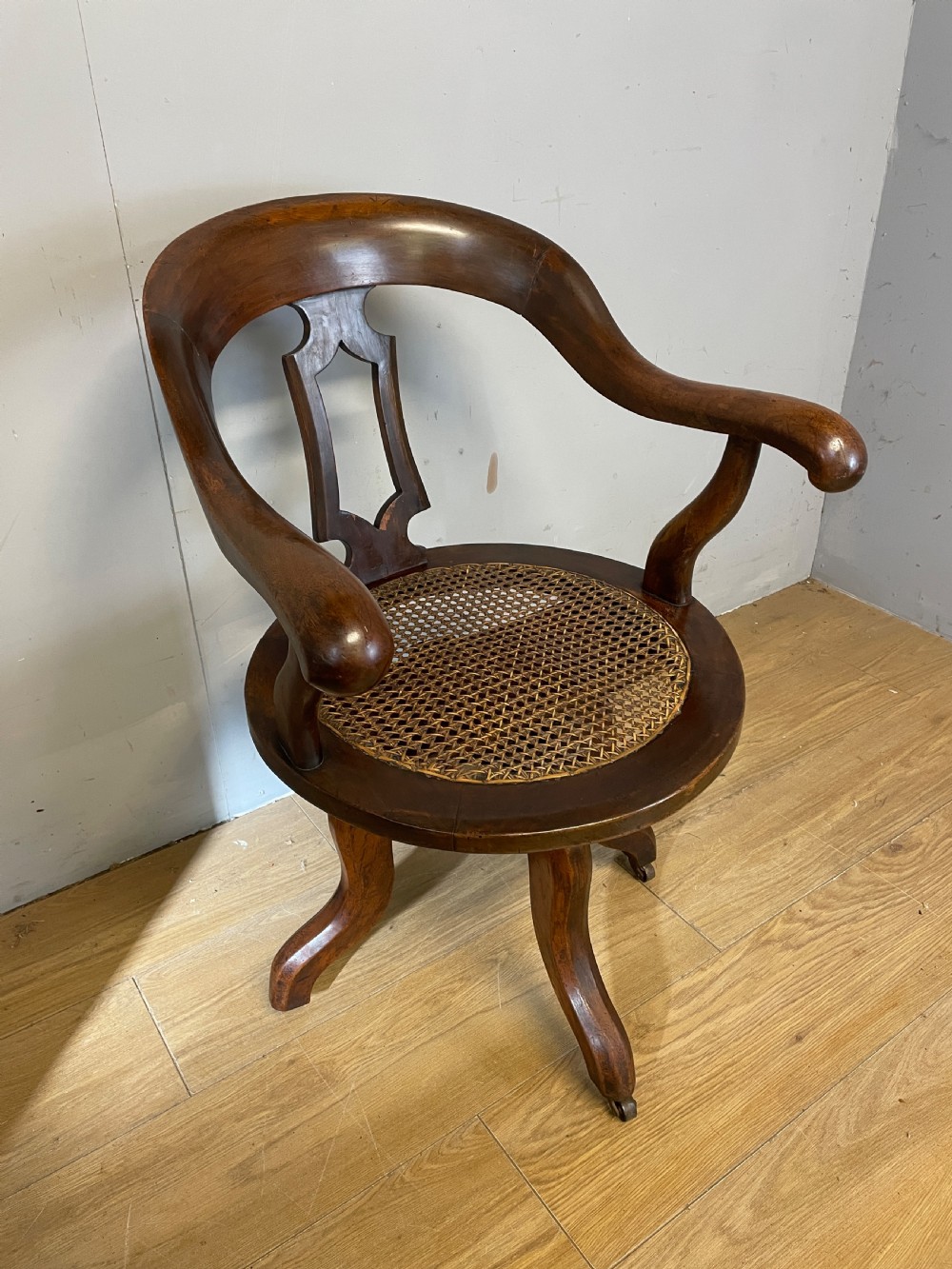 C19TH mahogany cane seated revolving desk chair