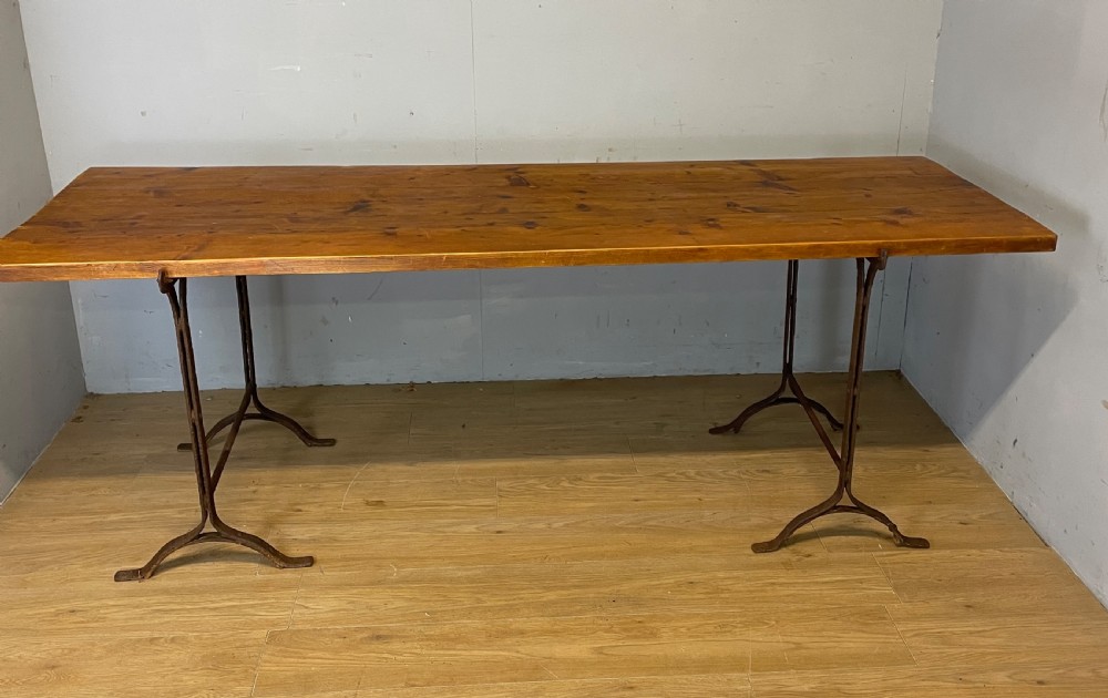 C19TH pine topped trestle table on wrought iron supports  View II