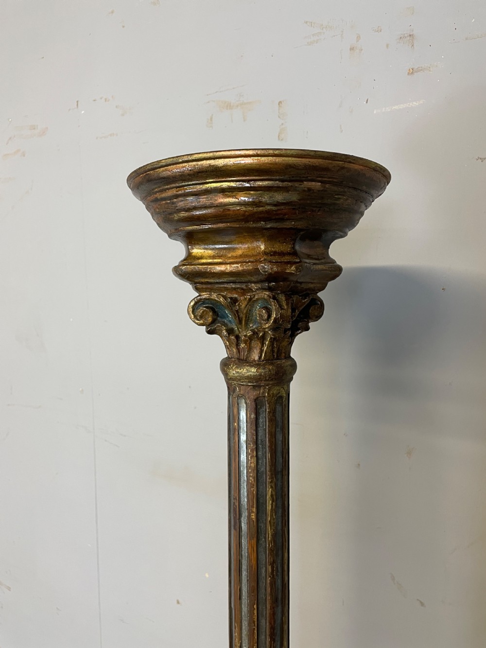 An 18th-century Italian carved wood torchere with a gilded Corinthian capital, fluted column, spiral twist shaft, and stepped base with scroll feet. View II