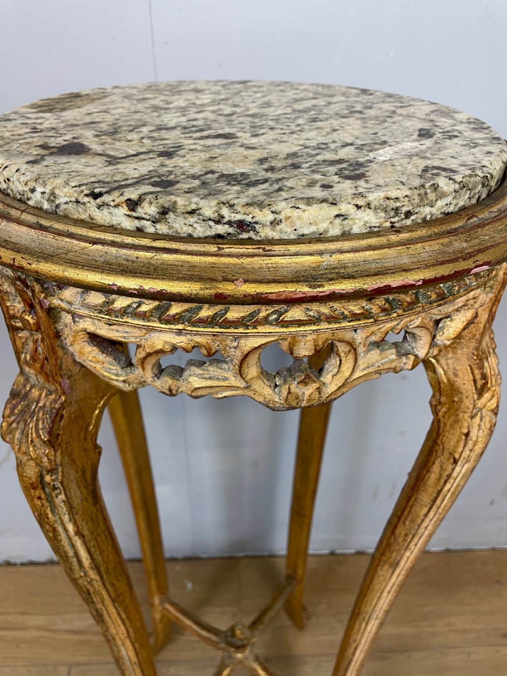 An Edwardian carved giltwood torchere featuring a circular grey marble top, slender cabriole legs, pierced aprons, and an X-frame stretcher. View III