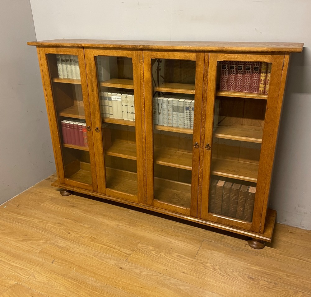 Arts and Crafts golden oak freestanding four  door glazed bookcase 