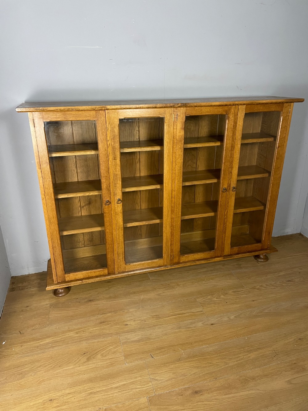 Arts and Crafts golden oak freestanding four  door glazed bookcase  View III
