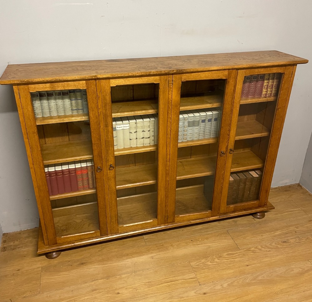 Arts and Crafts golden oak freestanding four  door glazed bookcase  View XII