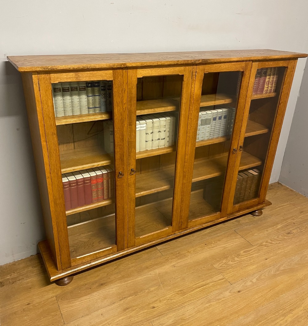 Arts and Crafts golden oak freestanding four  door glazed bookcase  View XIII