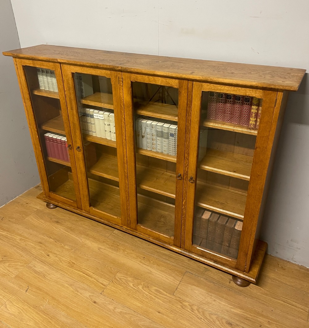 Arts and Crafts golden oak freestanding four  door glazed bookcase  View XIV