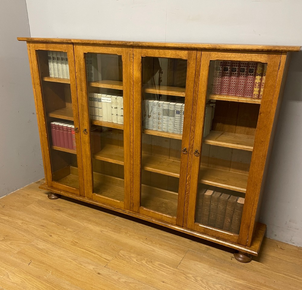Arts and Crafts golden oak freestanding four  door glazed bookcase  View XV