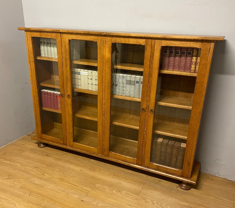 Arts and Crafts golden oak freestanding four  door glazed bookcase  View XVI