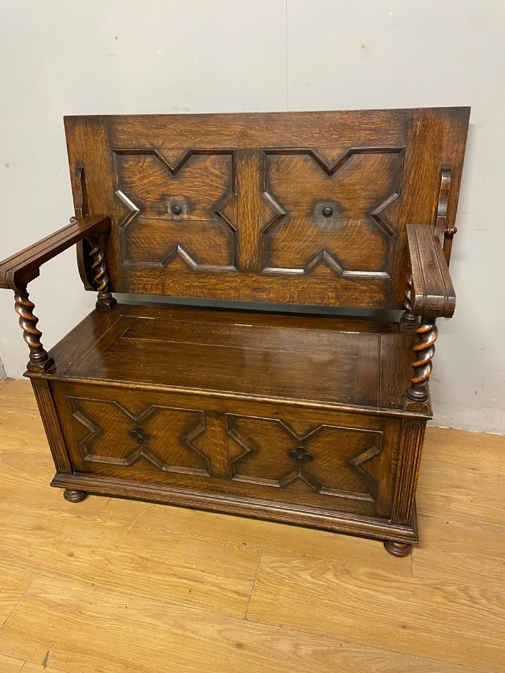 Oak panelled monks bench with barley twist supports circa 1920