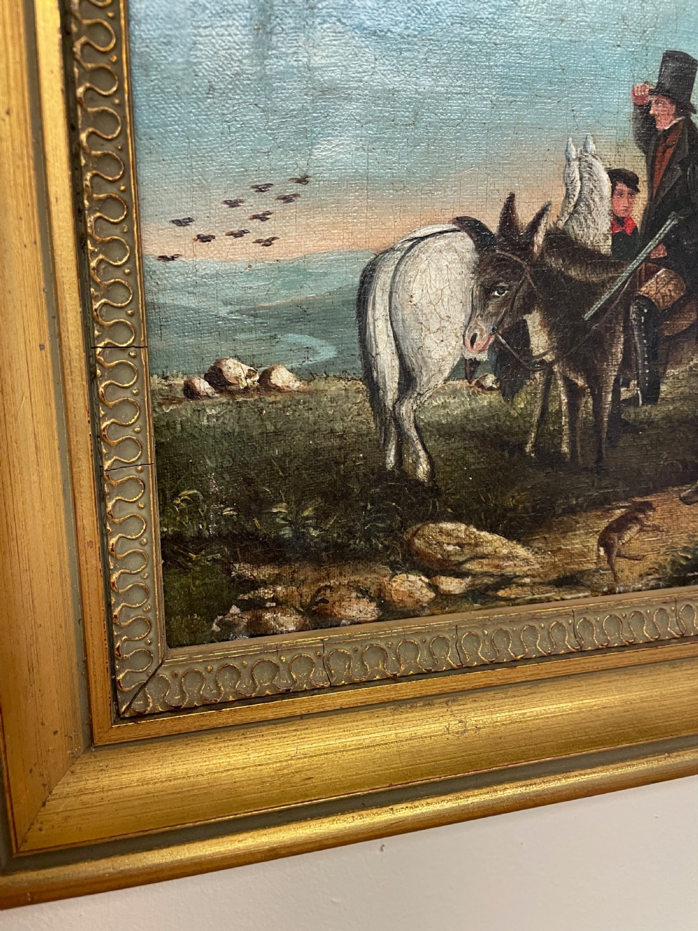 A 19th-century oil painting on canvas depicting riders and dogs in a rural landscape set within a moulded gilt frame. View VI