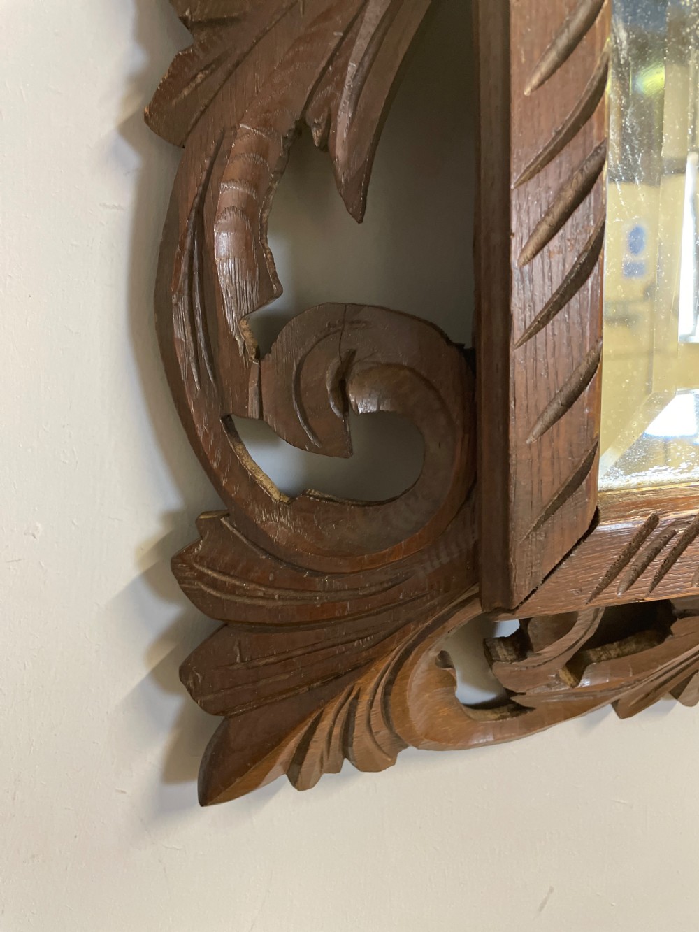 A rectangular 19th-century wall mirror with a bevelled glass plate set inside a deeply carved oak frame featuring acanthus leaves. View VII