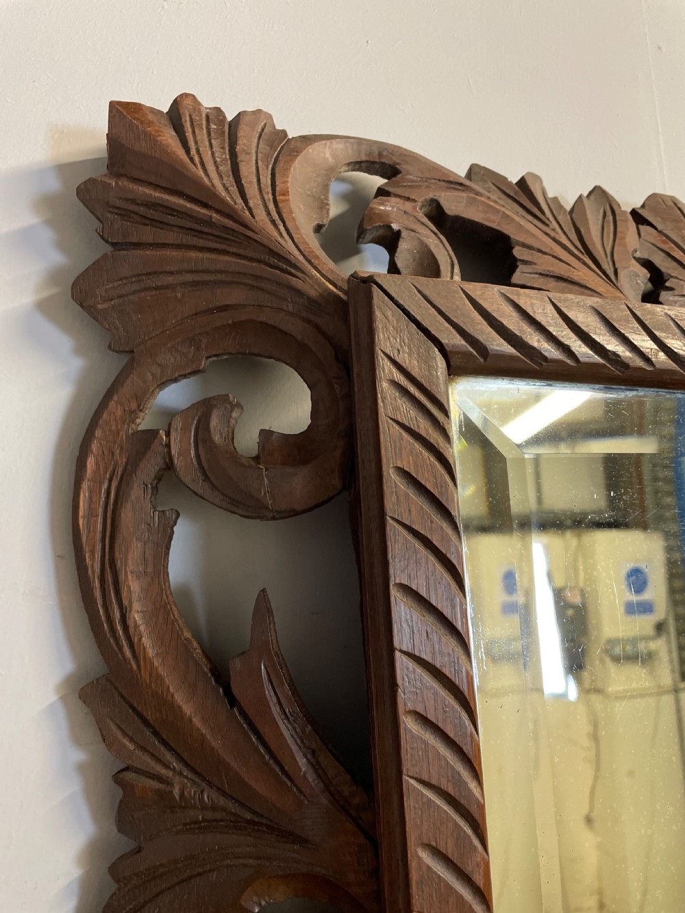 A rectangular 19th-century wall mirror with a bevelled glass plate set inside a deeply carved oak frame featuring acanthus leaves. View VIII