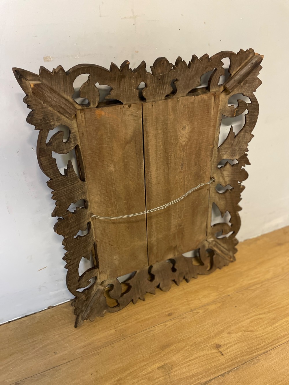 A rectangular 19th-century wall mirror with a bevelled glass plate set inside a deeply carved oak frame featuring acanthus leaves. View IX