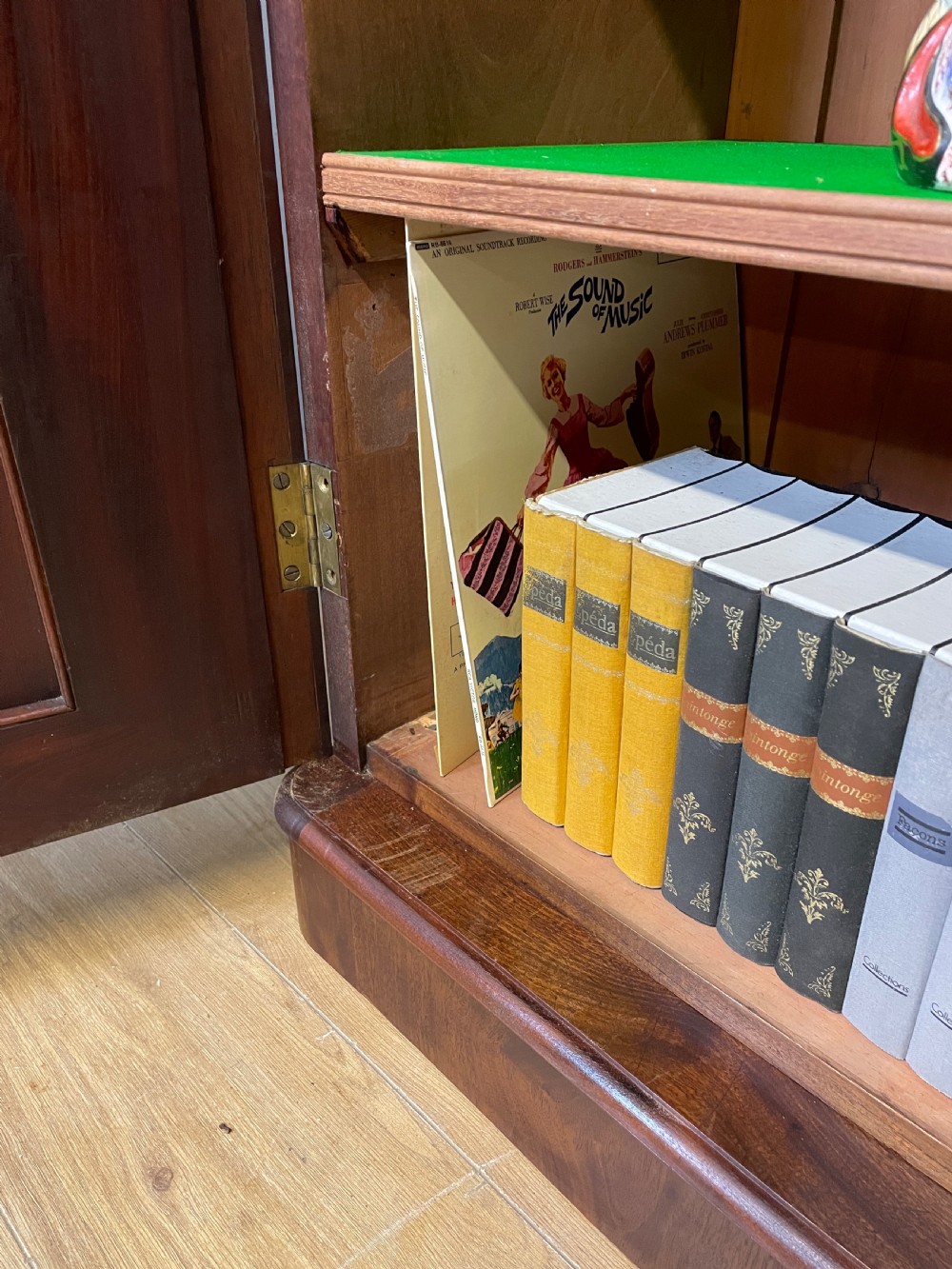 A nineteenth-century flame mahogany two-door library cupboard with arched door panels and a plinth base. View XII